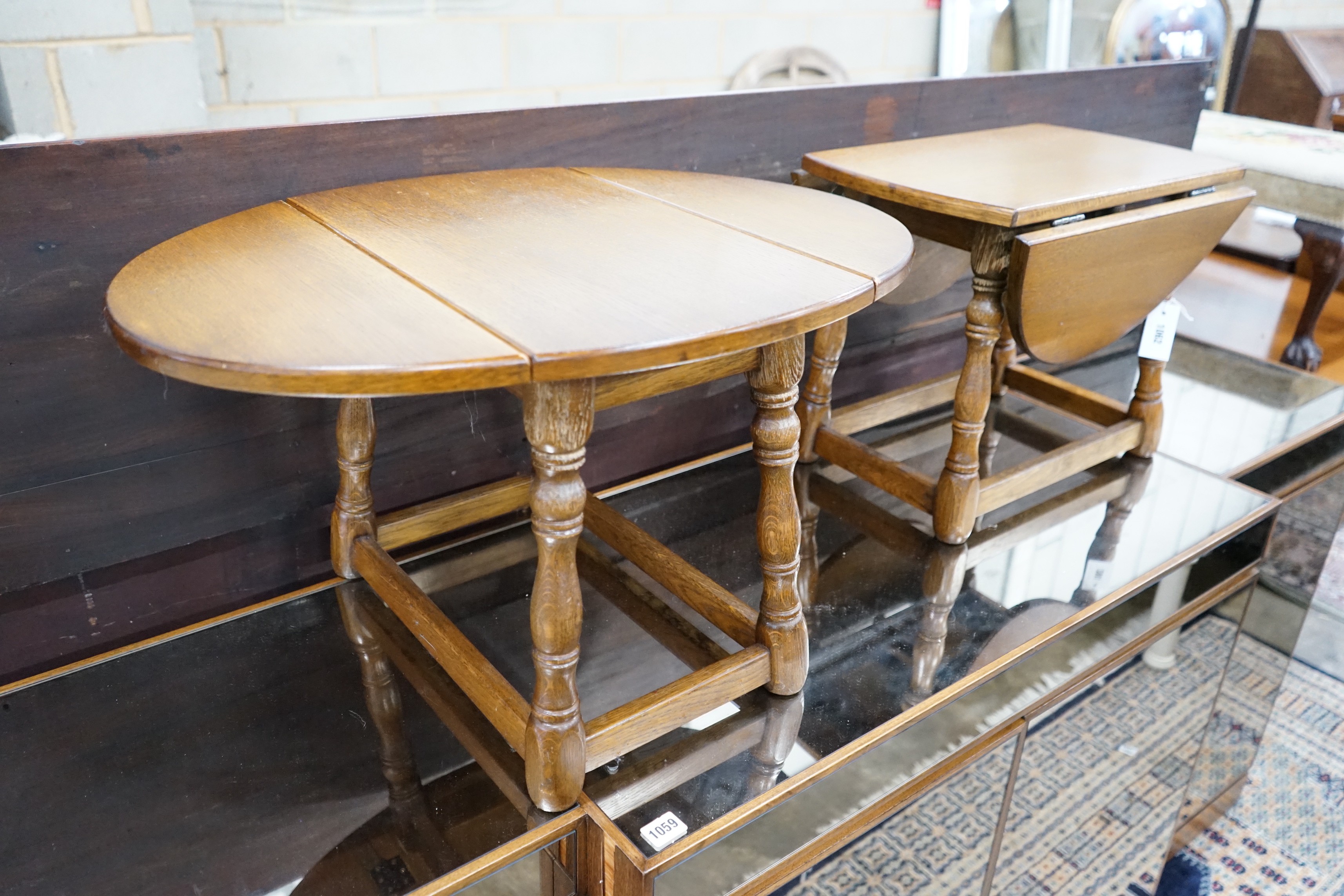 A pair of 18th century style oak drop flap occasional tables width extended 68cms, depth 50cms, height 39cms.